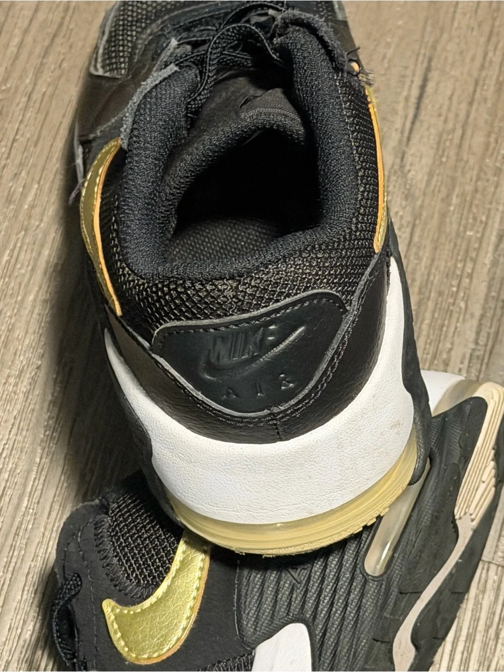 Nike Kids Black Sneakers with Gold Swoosh